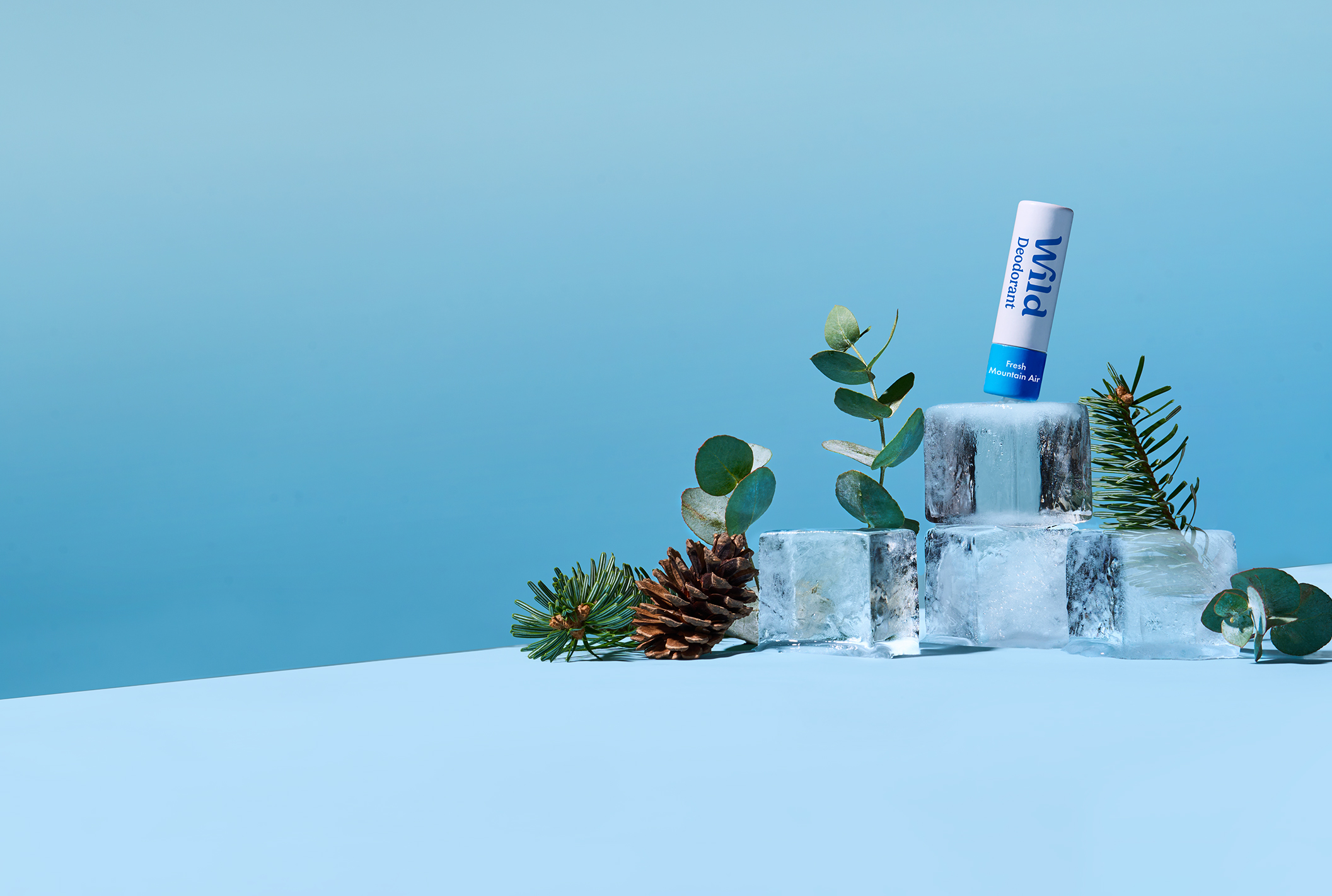 Caption: a tube of toothpaste sitting on top of ice cubes