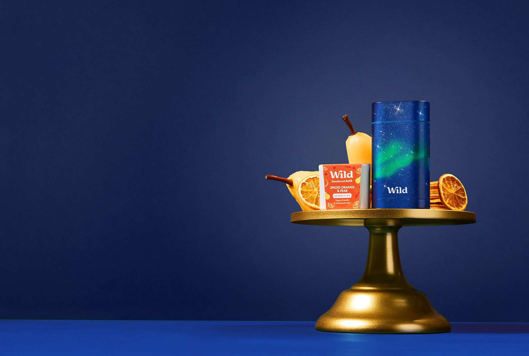 Caption: a candle holder with a candle, orange slices, and other items on it