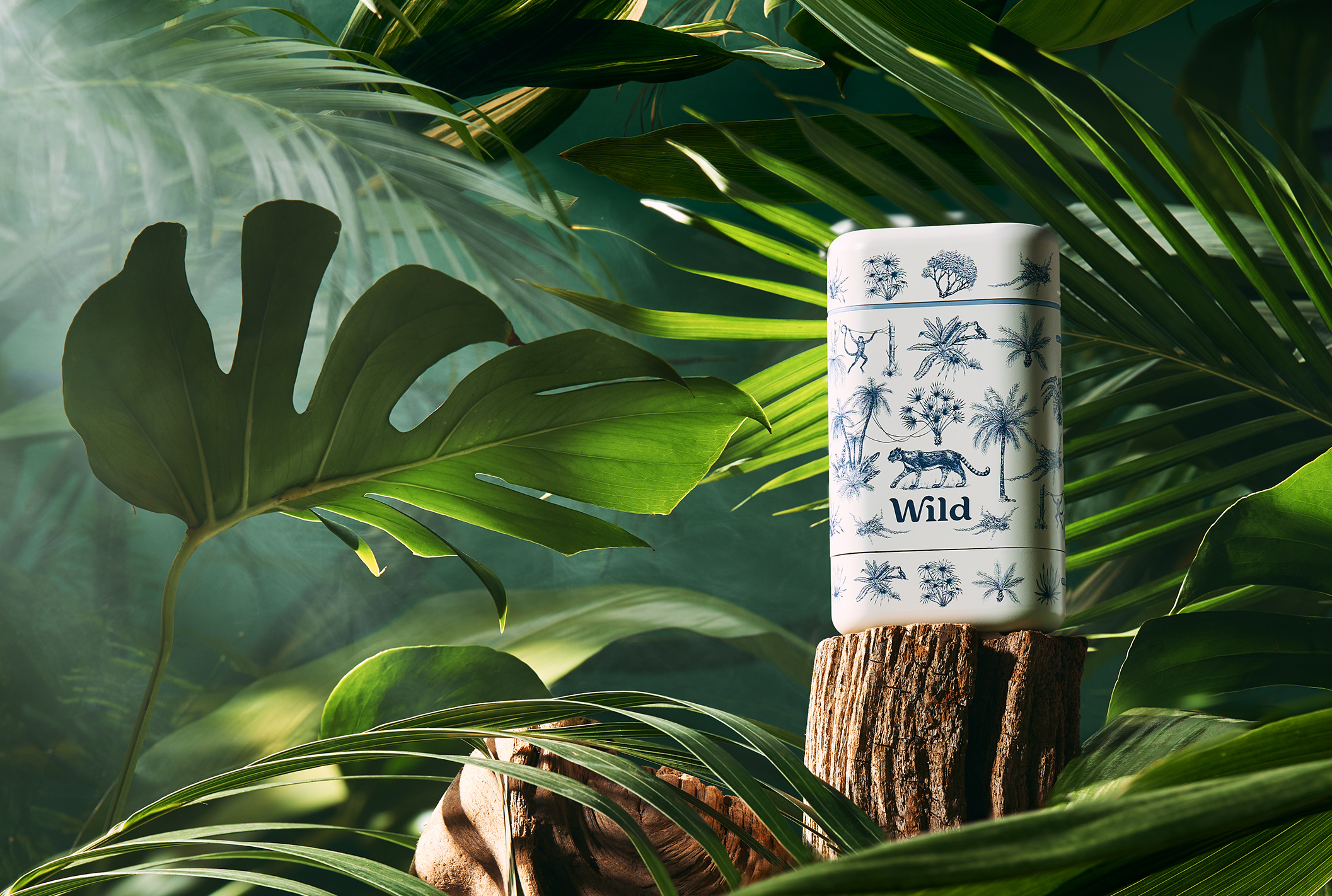 Caption: a white and blue candle sitting on top of a tree stump