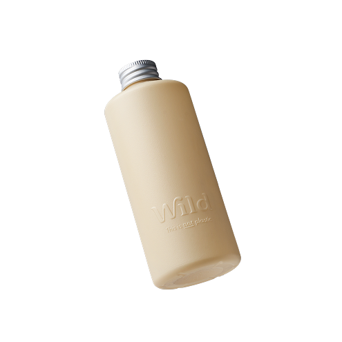 Caption: a white bottle with a silver lid on a black background