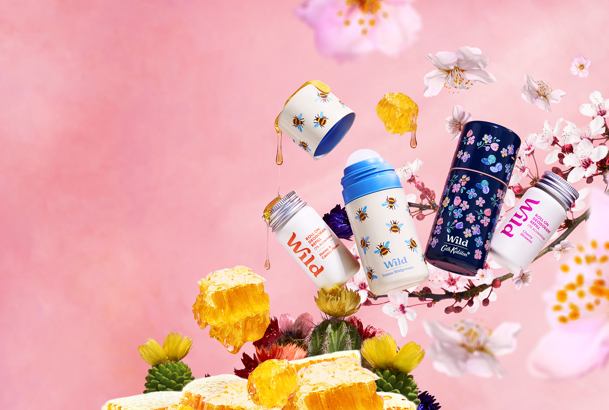 Caption: a pink background with flowers and a bunch of baby bottles