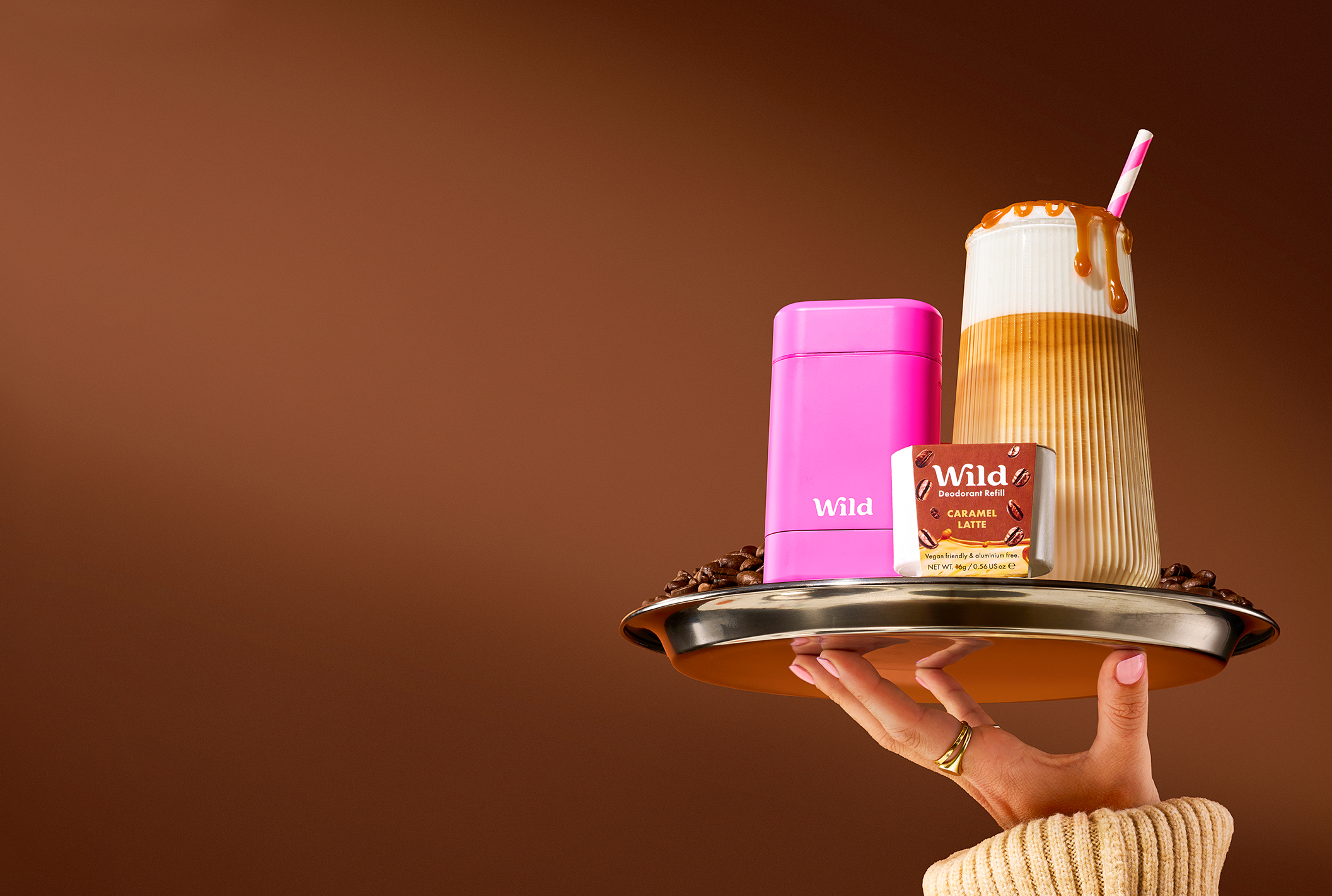 Caption: a woman holding a tray with two cups on it