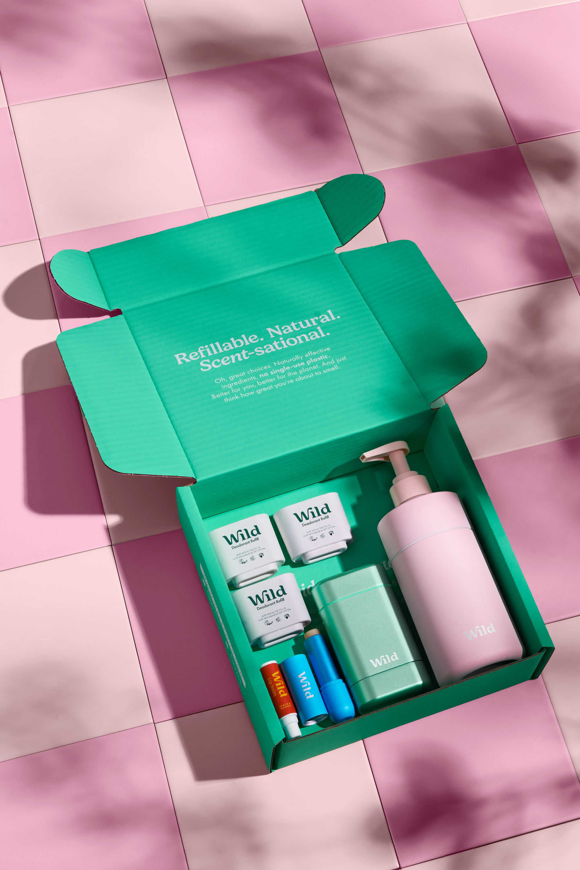 Caption: a green box containing a lotion and a lotion bottle