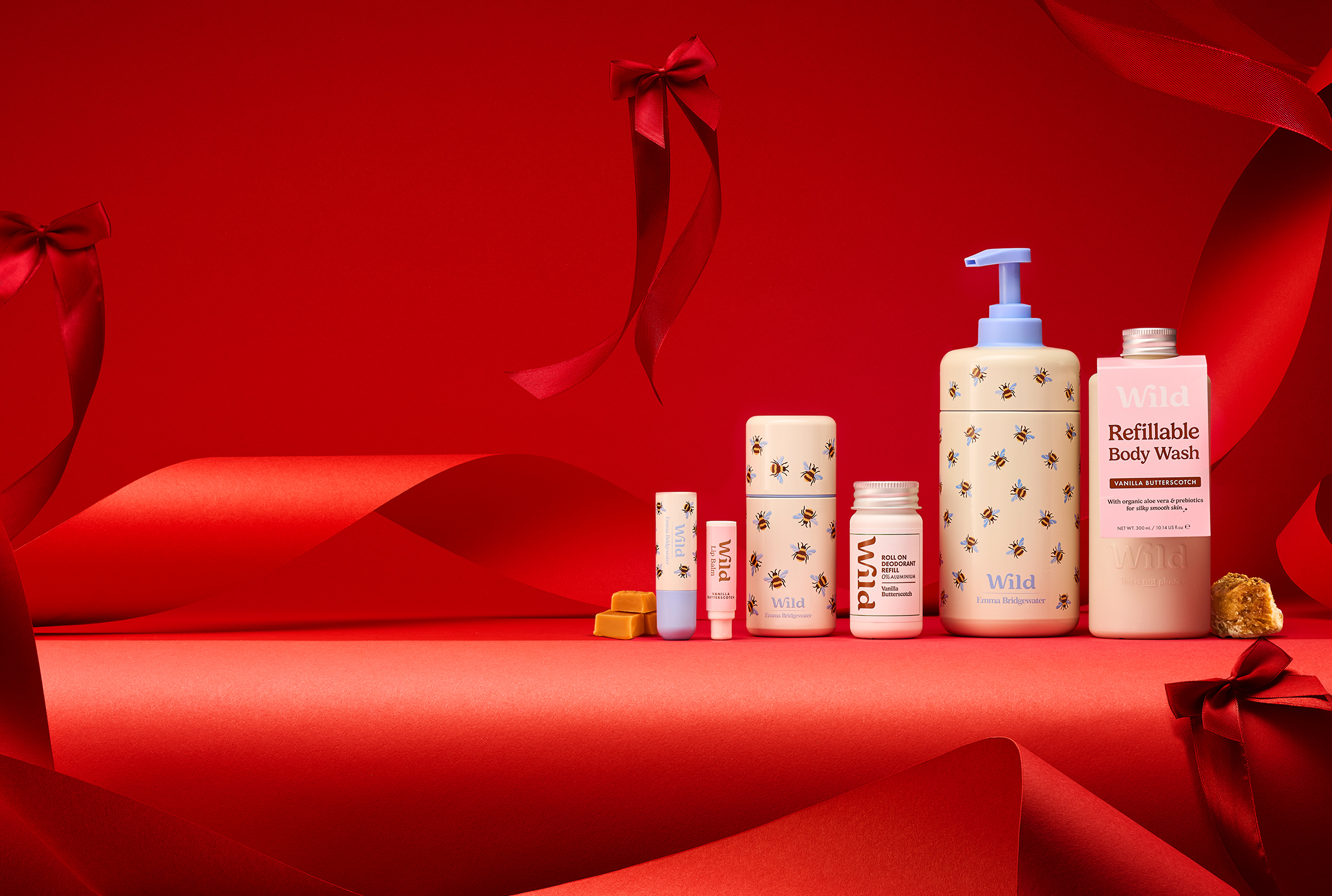 Caption: a red background with a variety of skin care products
