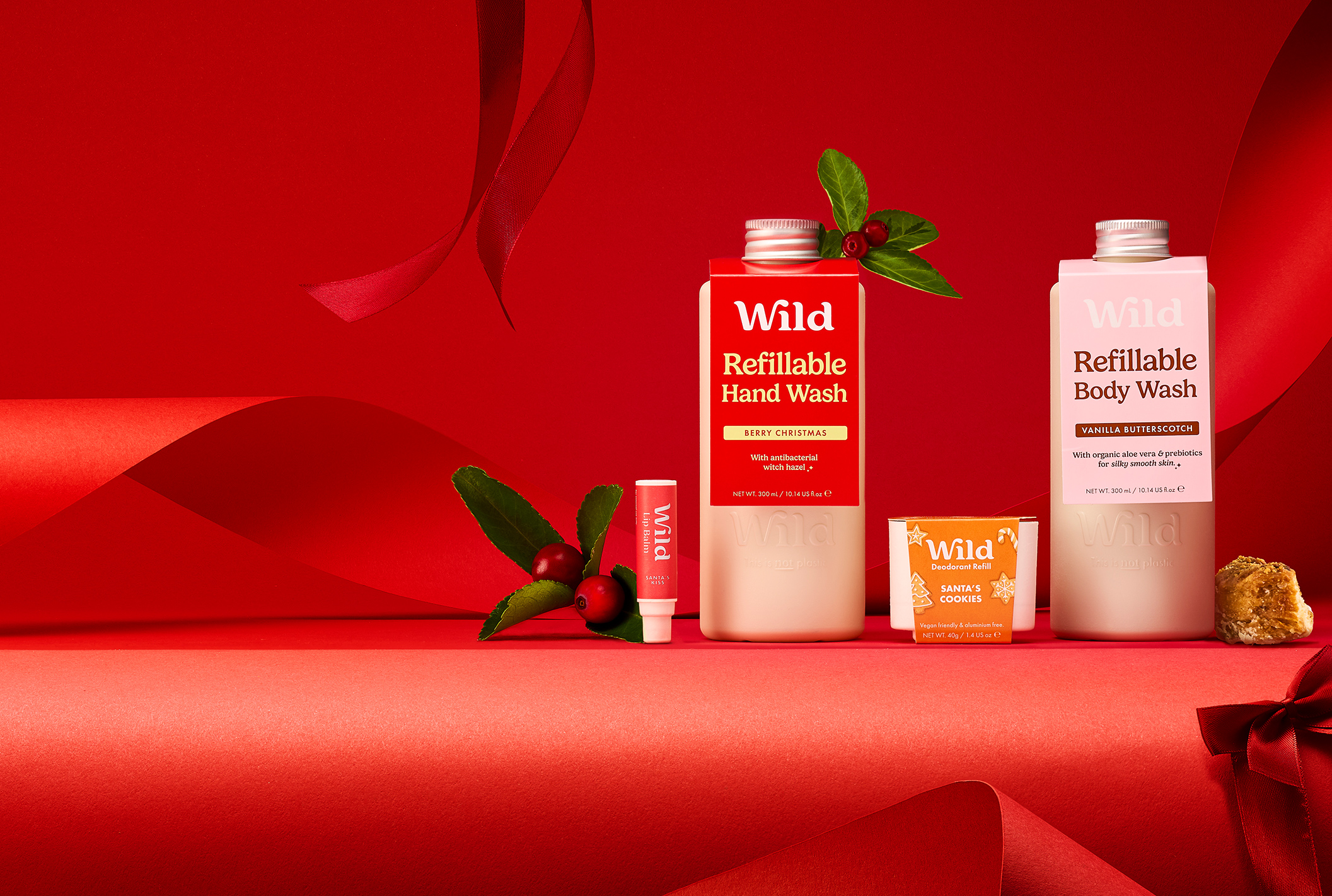 Caption: a red table topped with two bottles of body wash