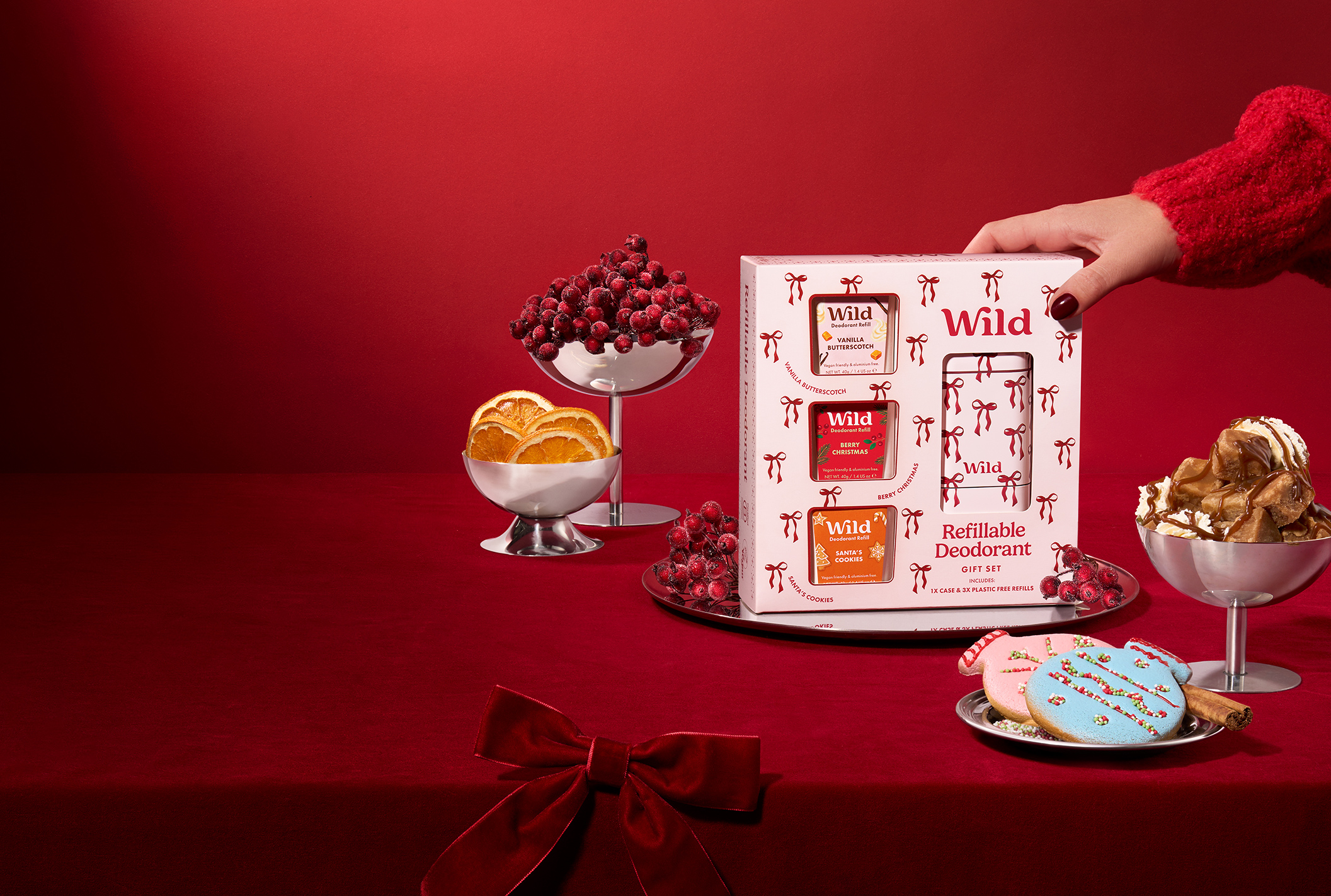 Caption: a red table topped with lots of desserts