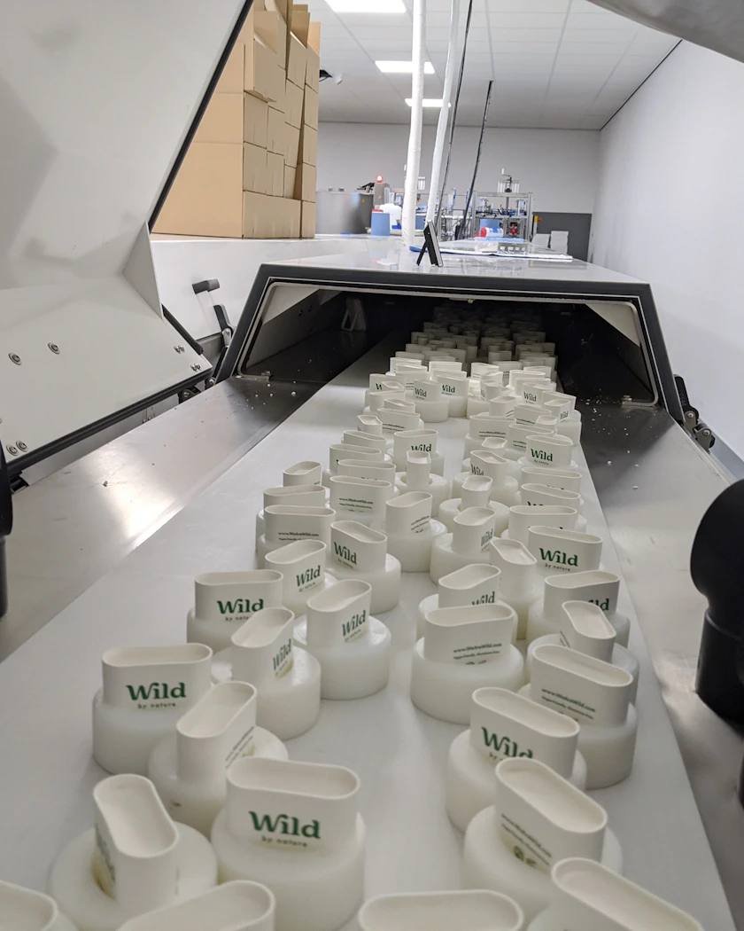 Caption: a conveyor belt filled with lots of white cups