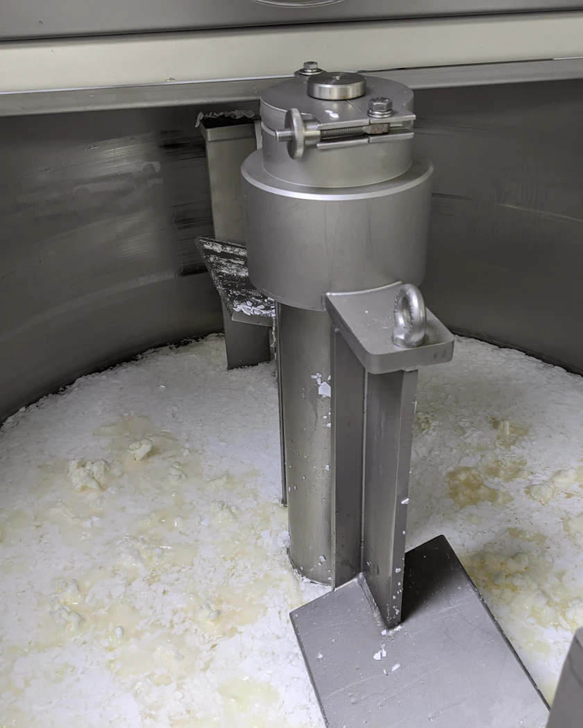 Caption: a machine that is making some kind of food