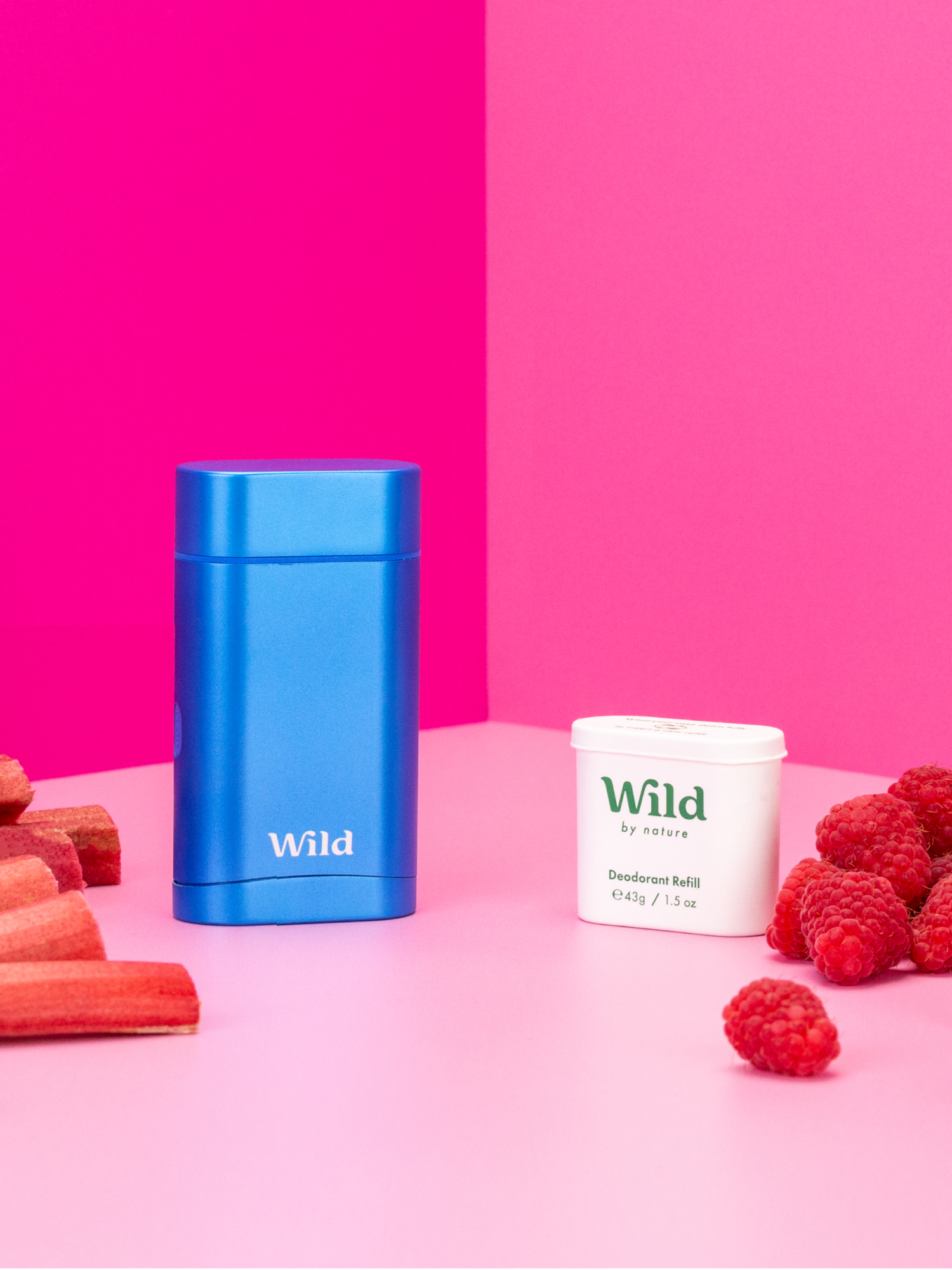 Caption: raspberries, carrots, and a blue container of wpid on a