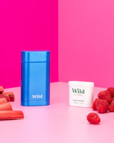 Caption: raspberries, carrots, and a blue container of wpid on a