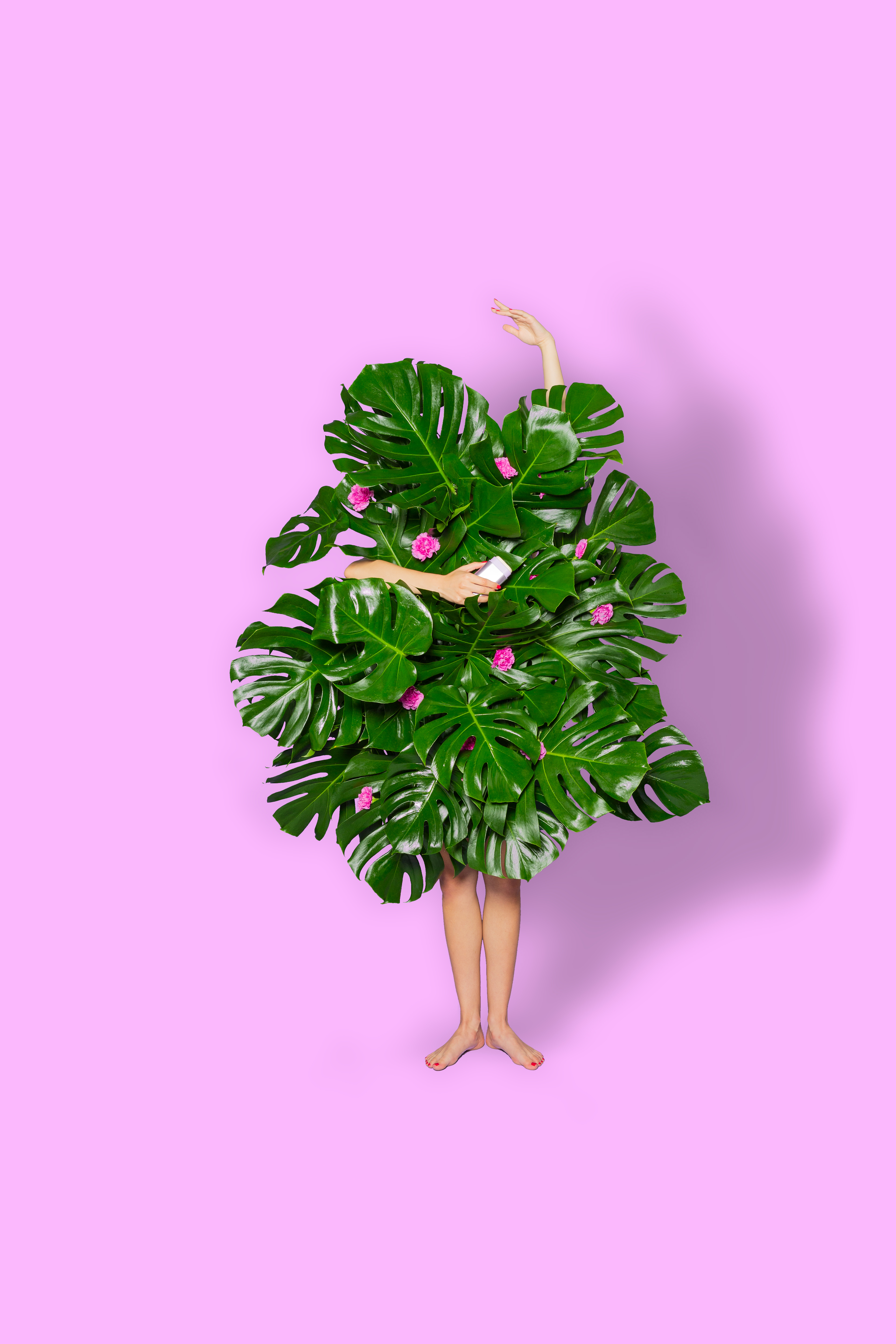 Caption: a woman standing in front of a large green plant