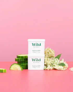 Caption: a pink table with a container of wild