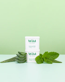 Caption: a couple of green leaves sitting on top of a table