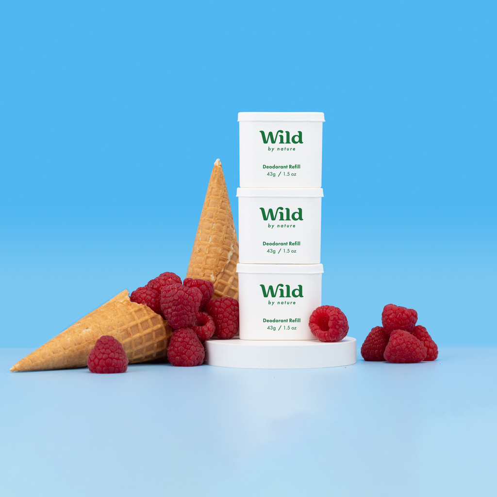 Caption: a stack of three ice cream cones sitting next to raspberries