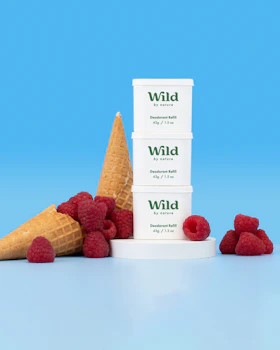 Caption: a stack of three ice cream cones sitting next to raspberries