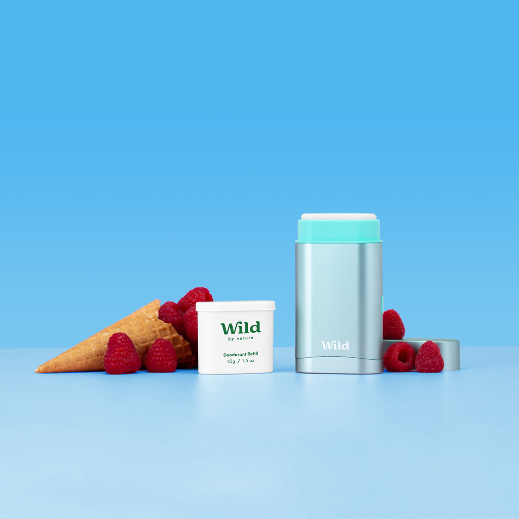 Caption: a blue background with raspberries and a cup of yogurt