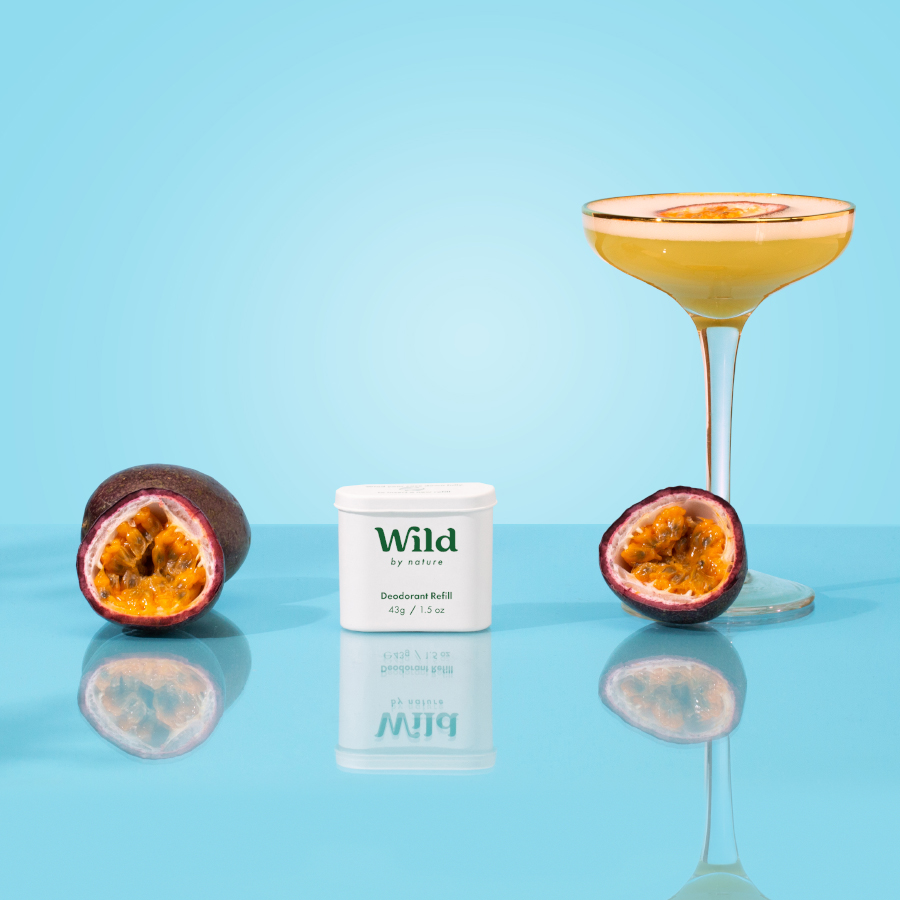 Caption: a glass of wine next to a half - eaten fruit