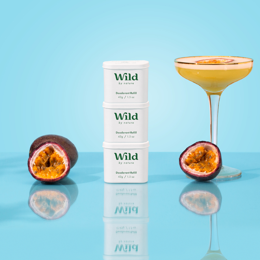 Caption: a glass filled with a drink next to a can of wild