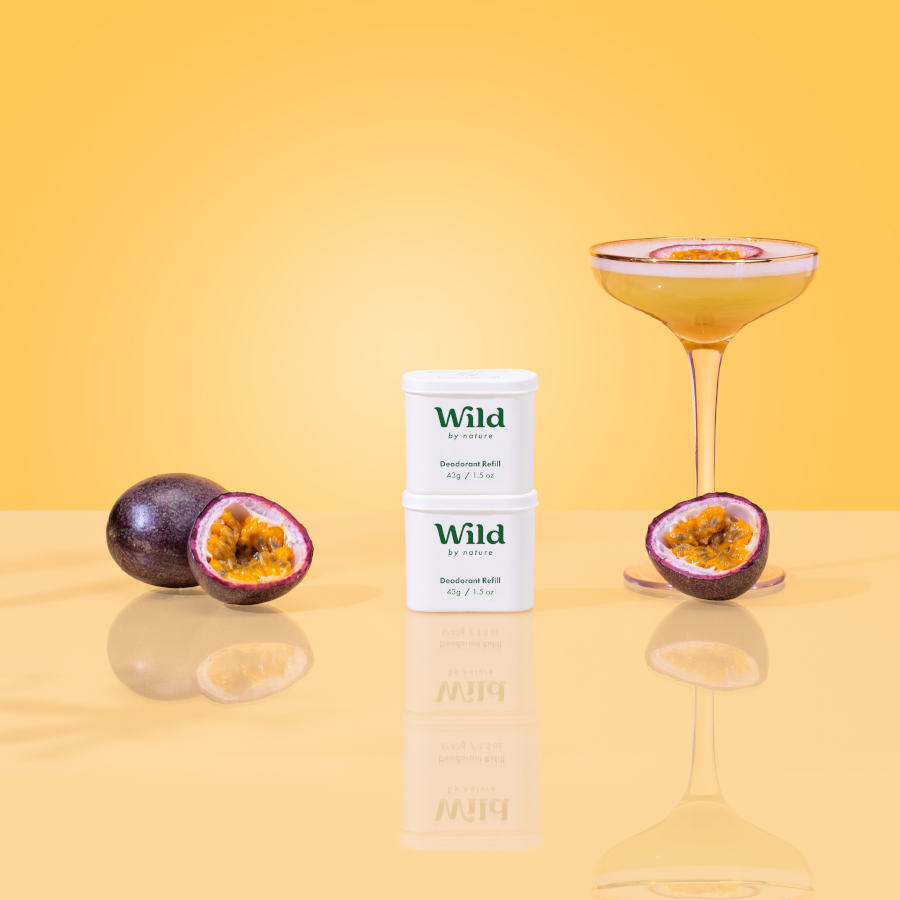 Caption: a glass of wine and some fruit on a table