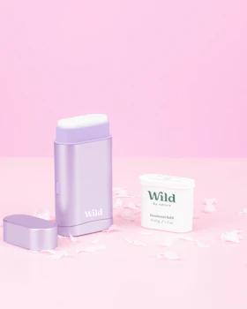 Caption: a white container sitting next to a white container on a pink surface