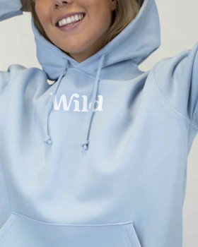 Caption: a woman wearing a blue hoodie with the word wild printed on it