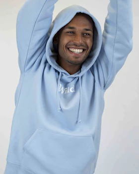 Caption: a man in a blue hoodie is smiling