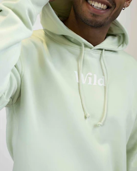 Caption: a man in a light green hoodie smiling