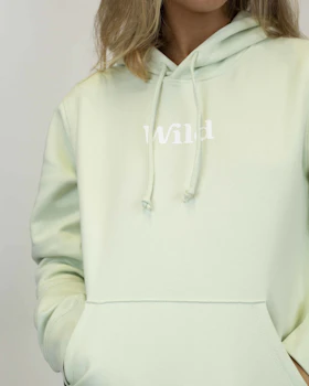 Caption: a woman wearing a light green hoodie with the word hawaii printed on it