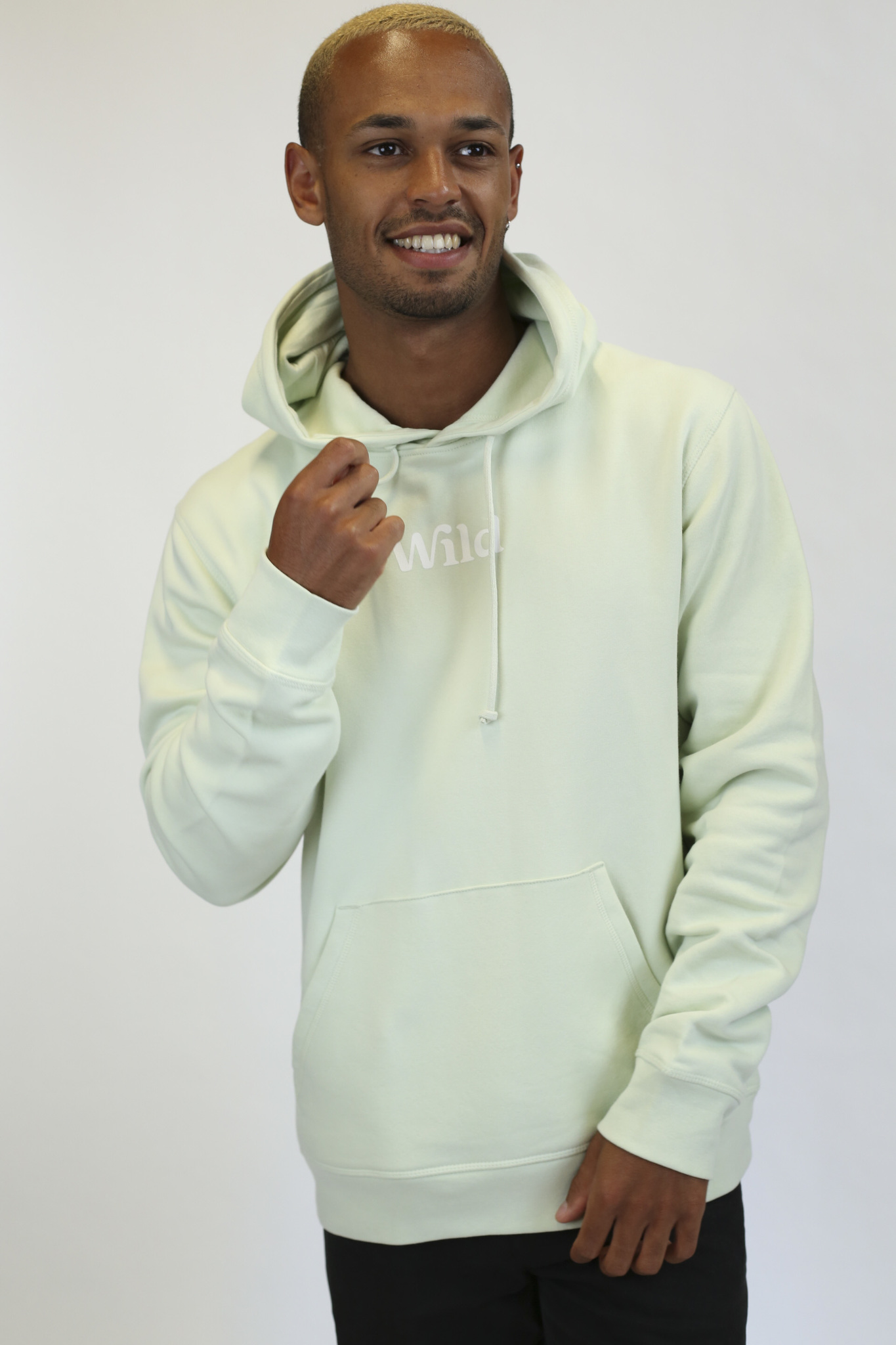 Caption: a man in a white hoodie is smiling