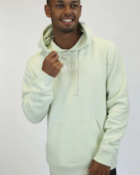Caption: a man in a white hoodie is smiling