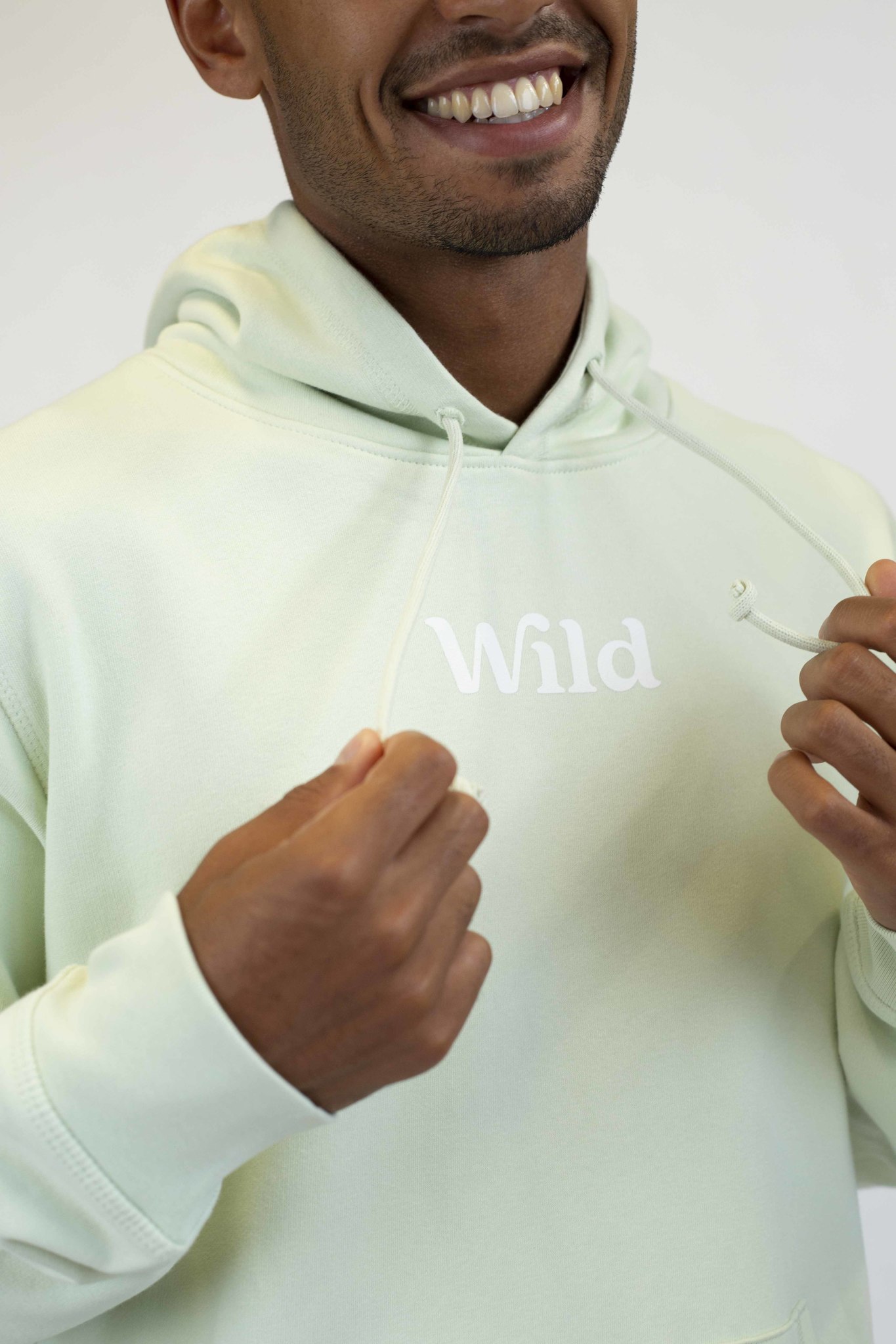 Caption: a man in a white hoodie is smiling