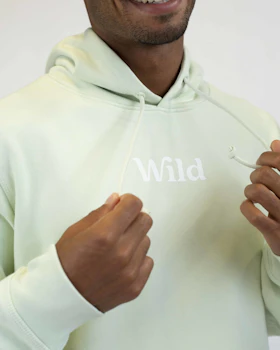 Caption: a man in a white hoodie is smiling