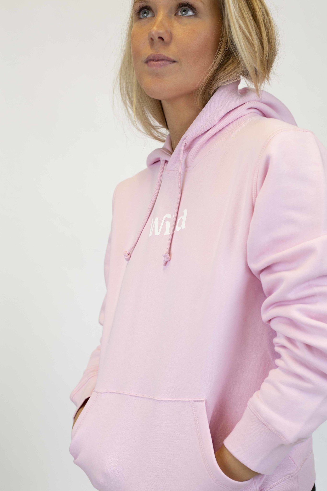 Caption: a woman in a pink hoodie is posing for a picture