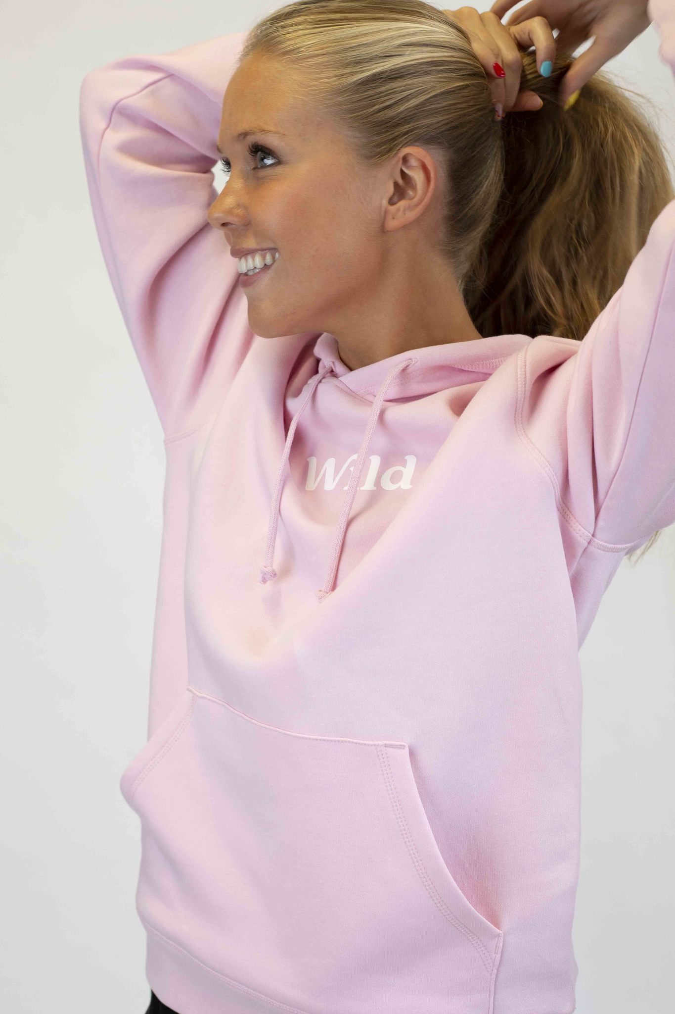 Caption: a woman with her hair in a ponytail