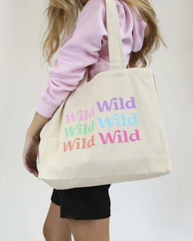 Caption: a woman carrying a tote bag with words on it