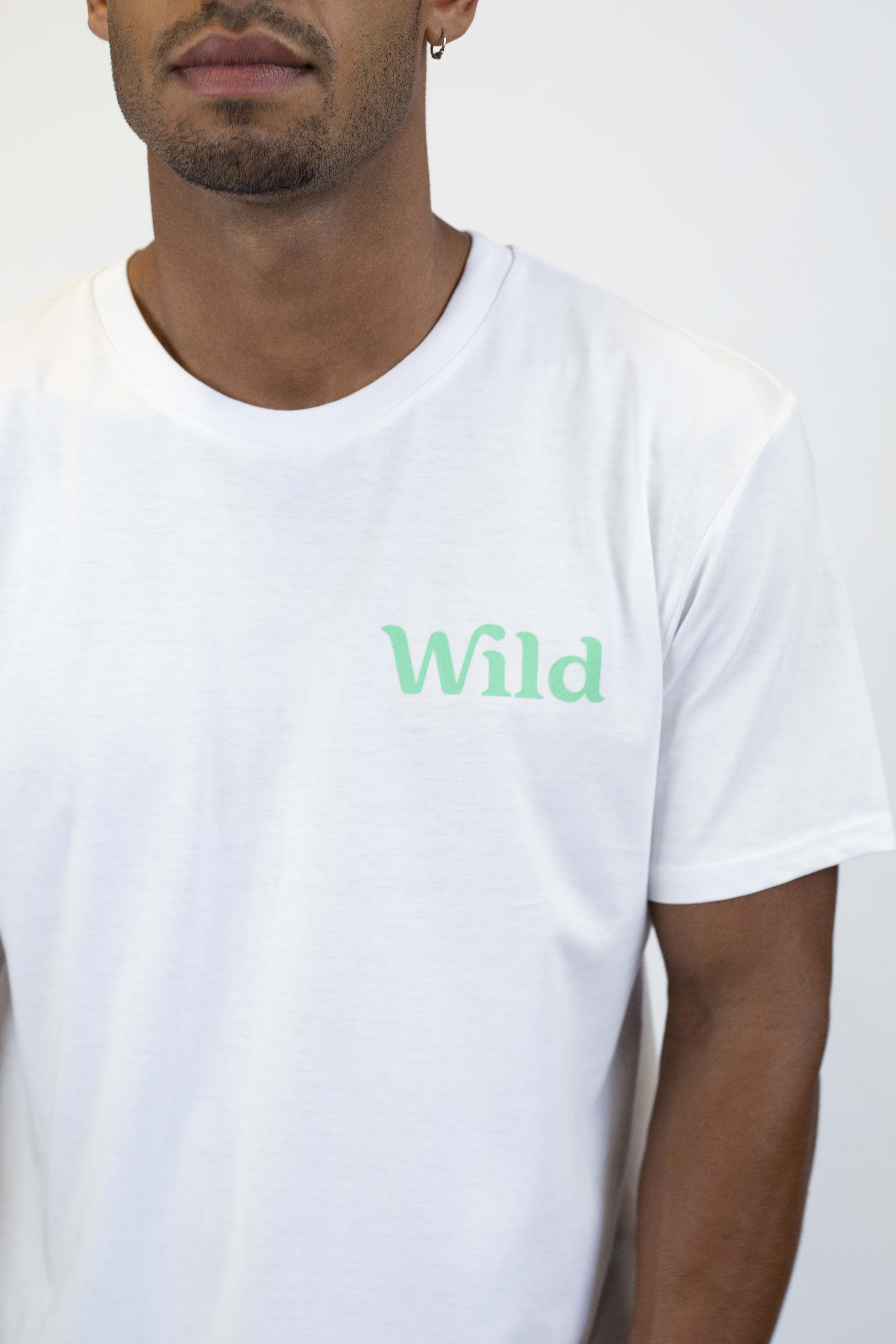 Caption: a man wearing a white t - shirt with the word wild printed on it