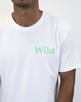 Caption: a man wearing a white t - shirt with the word wild printed on it