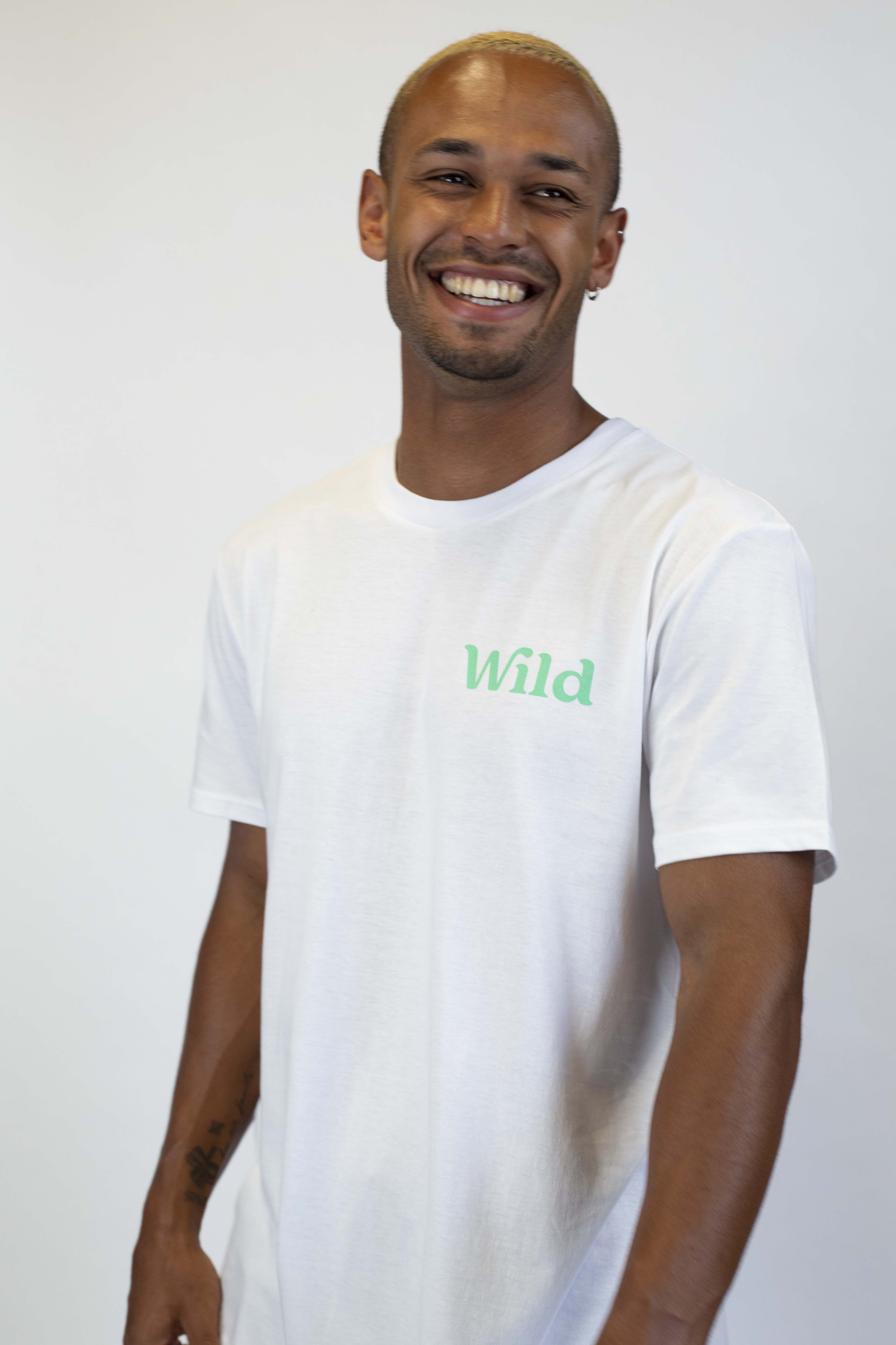 Caption: a man in a white shirt smiles at the camera
