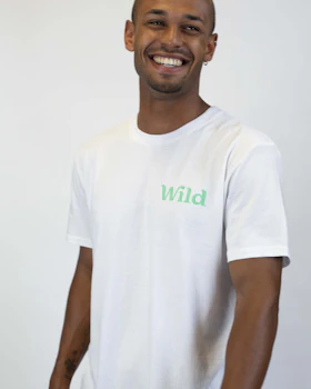 Caption: a man in a white shirt smiles at the camera