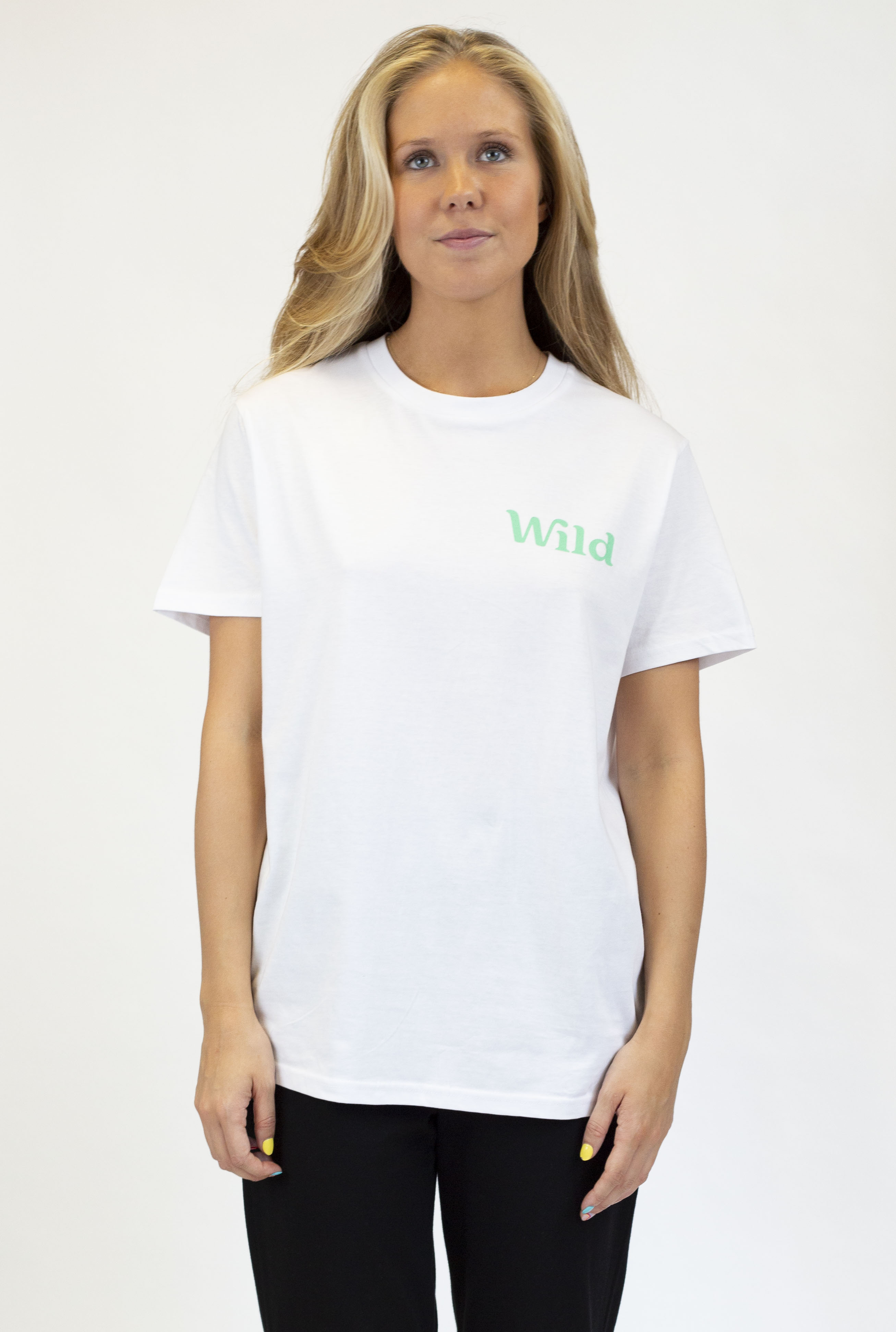 Caption: a woman wearing a white shirt and black pants