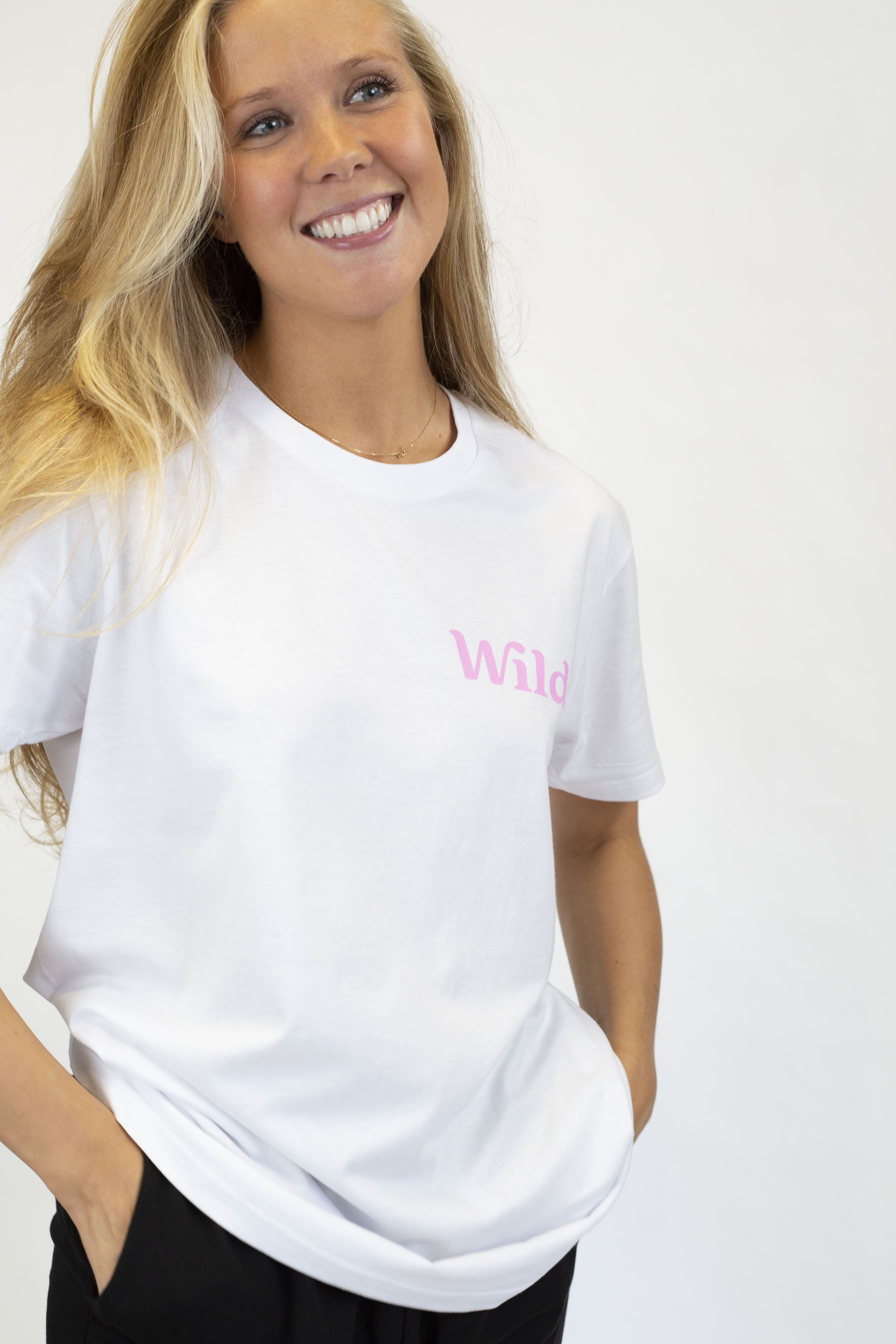 Caption: a woman wearing a white shirt and black pants