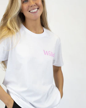 Caption: a woman wearing a white shirt and black pants