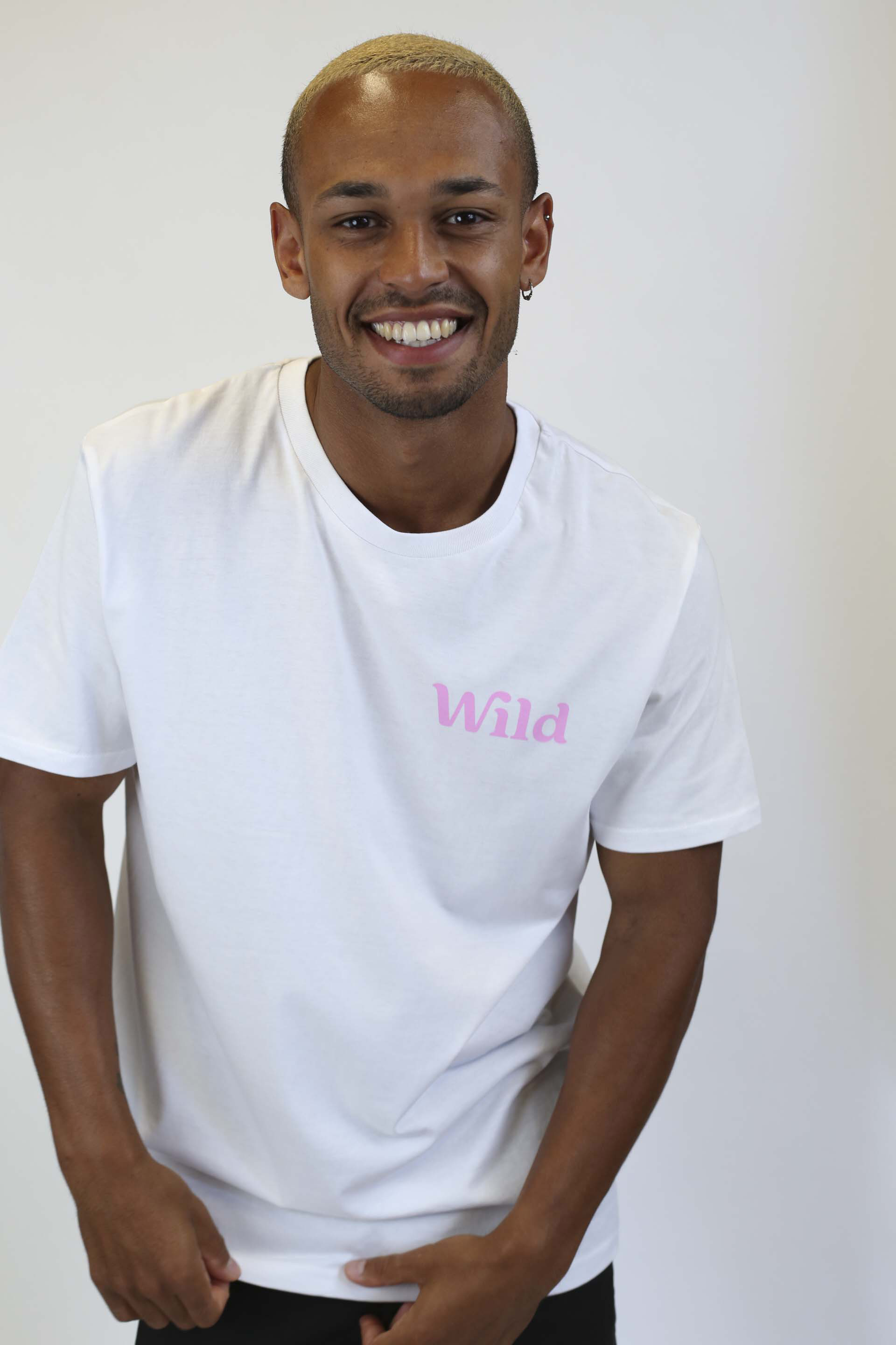 Caption: a man in a white t - shirt with the word wild on it