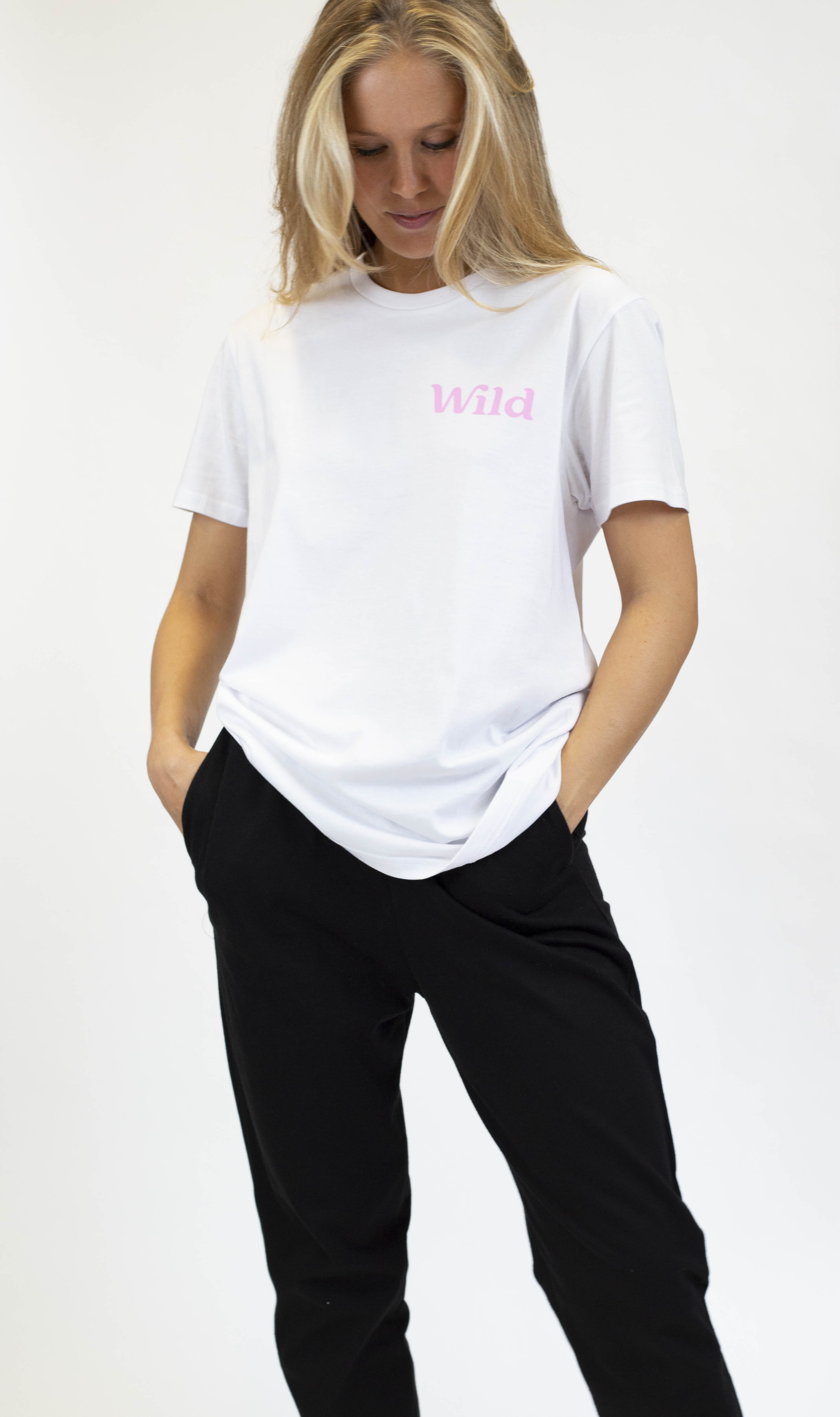 Caption: a woman in a white shirt and black pants