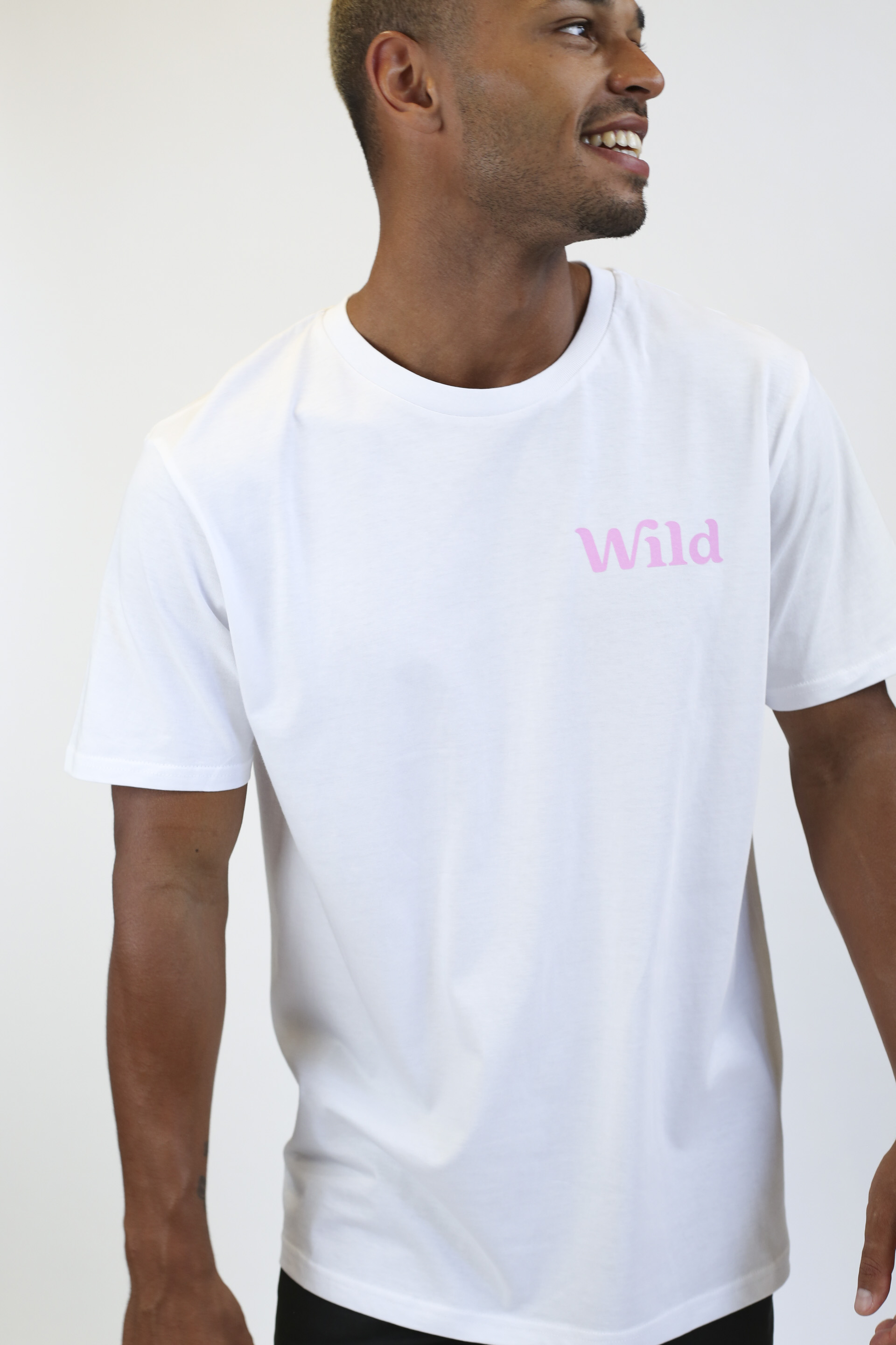 Caption: a man wearing a white t - shirt with the word wild printed on it