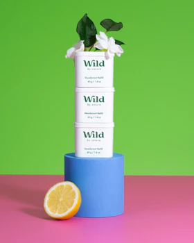 Caption: a stack of three boxes with a flower on top of it