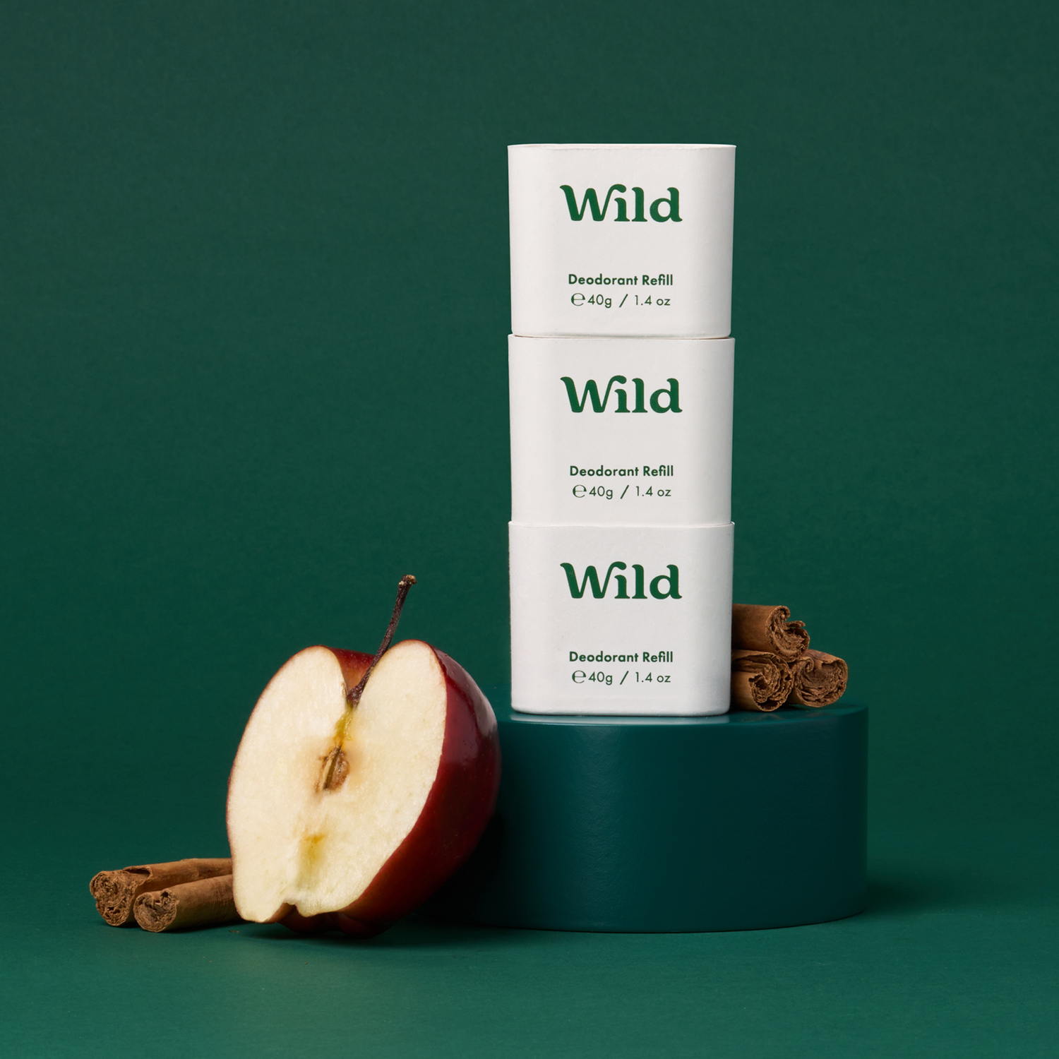 Caption: three boxes of wild apple spice next to an apple