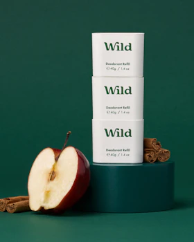 Caption: three boxes of wild apple spice next to an apple