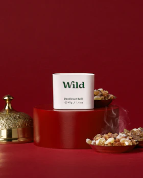 Caption: a red table topped with a red container filled with popcorn