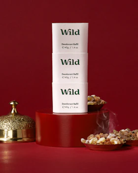 Caption: a stack of three boxes sitting on top of a red table